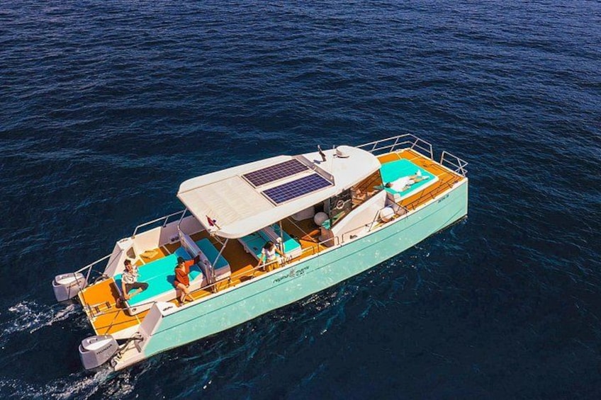 A boat with a covered deck, seating, and a small cabin. 5