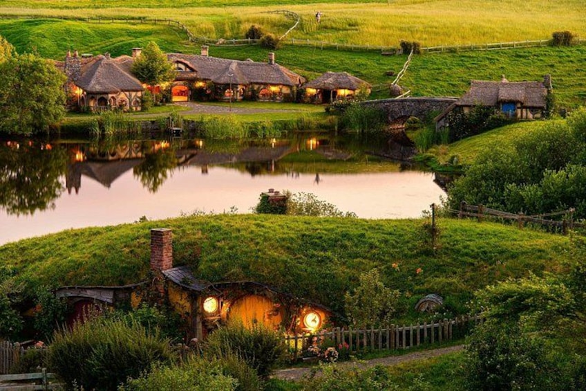 A rural village with houses, a pond, and a bridge. 2
