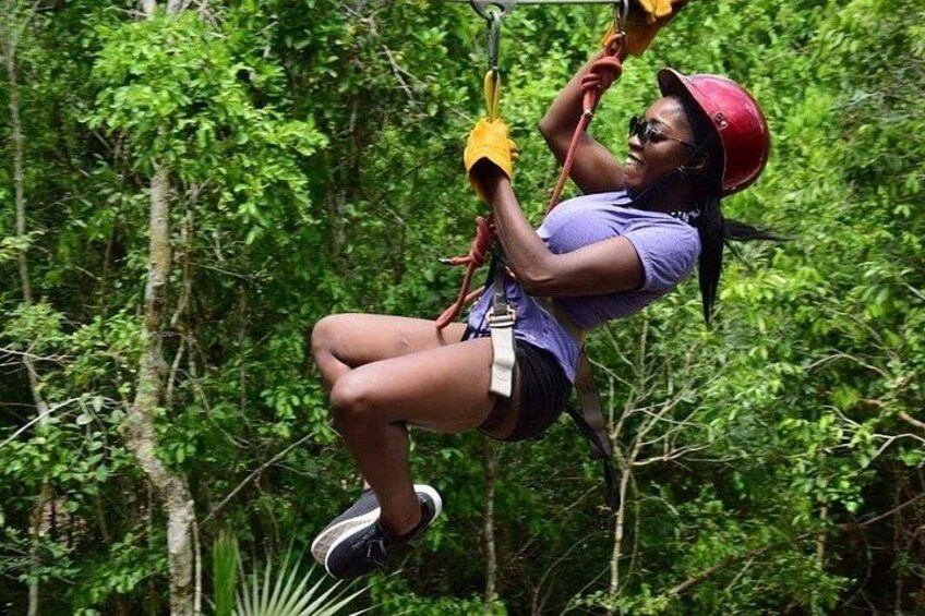 A person zip-lining through a forest. 4