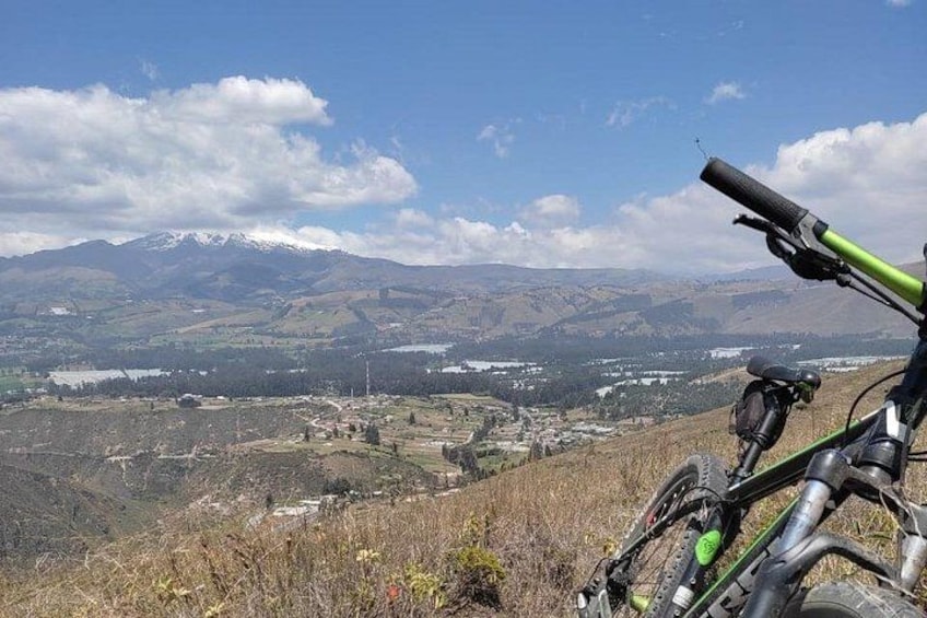 A mountain landscape with a bicycle in the foreground. 2
