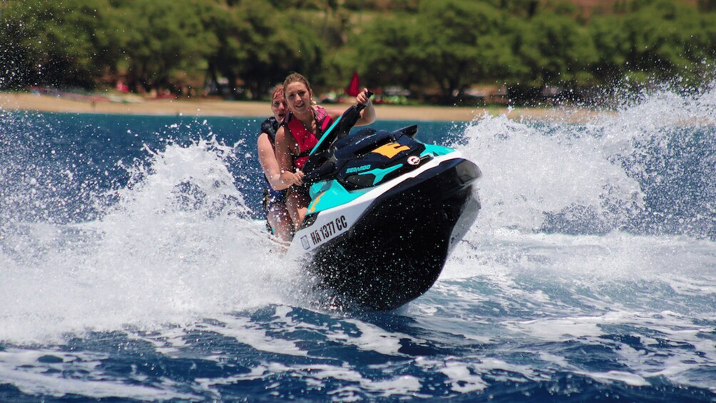 A person riding a jet ski on water with splashes around. 5