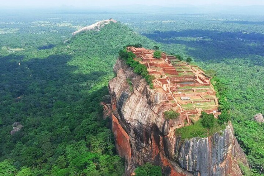 A cliffside with ancient ruins and dense forest. 3