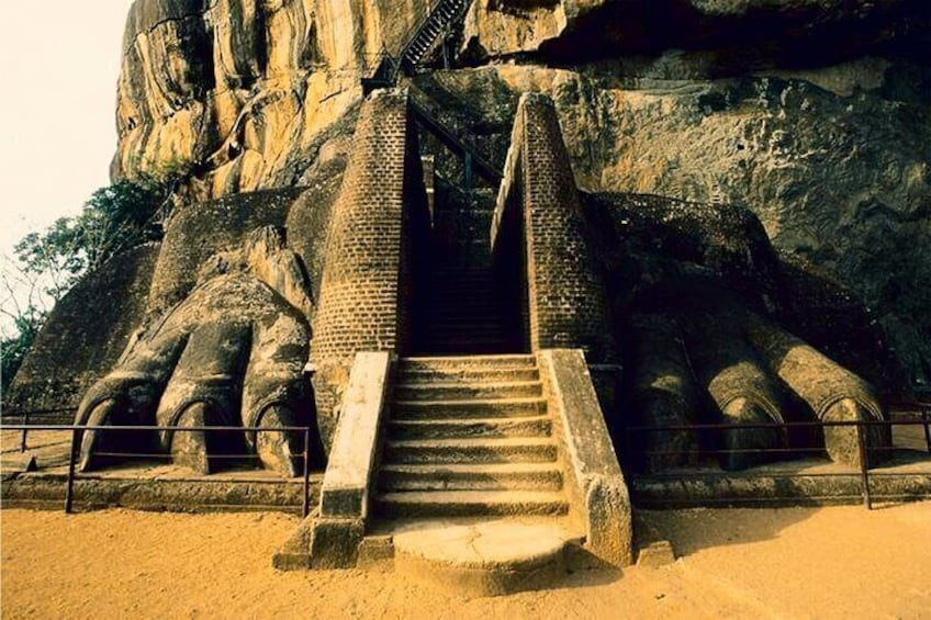 A large rock formation with a staircase leading up to a temple entrance. 2