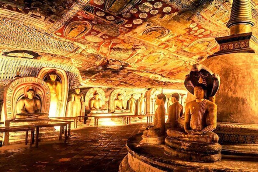 A temple interior with Buddha statues and intricate ceiling artwork. 5