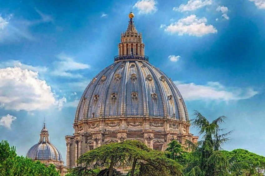 A large domed building with intricate architectural details, surrounded by lush greenery. 4