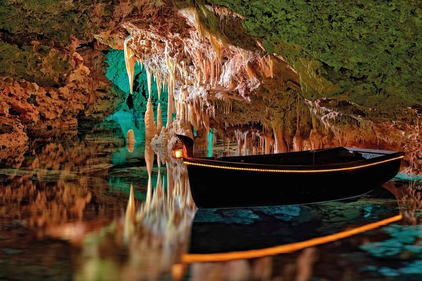 A boat in a cave with stalactites and stalagmites. 3