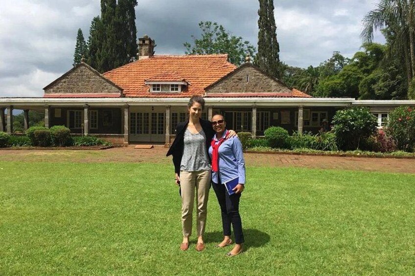 A large house with a red-tiled roof and a lawn in front. 2