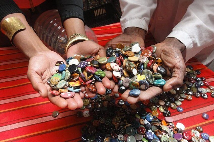 Hands holding a variety of colorful stones. 4