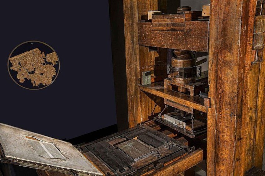An antique printing press with wooden components and metal parts. 2