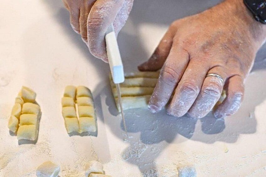 Hands cutting a block of material into smaller pieces. 2