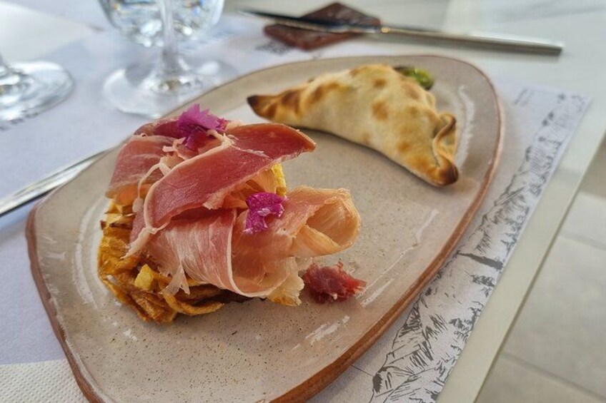 A plate with food, a glass, and a napkin. 3