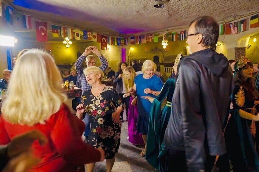 A group of people dancing in a room with flags on the wall. 2