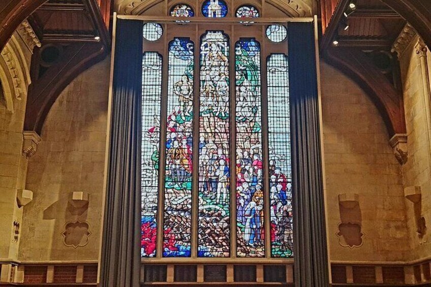 A large stained glass window with intricate designs and multiple colors. 4
