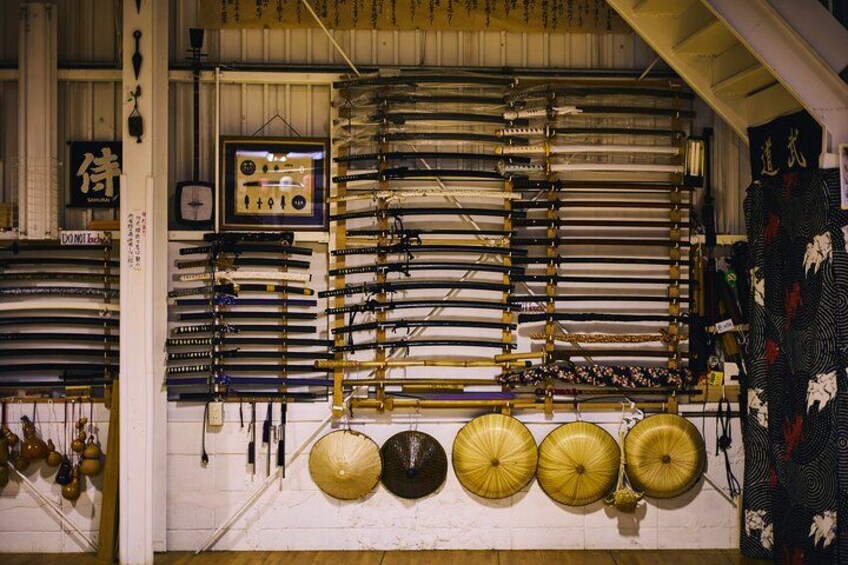 A display of various traditional Japanese swords and armor in a museum. 1
