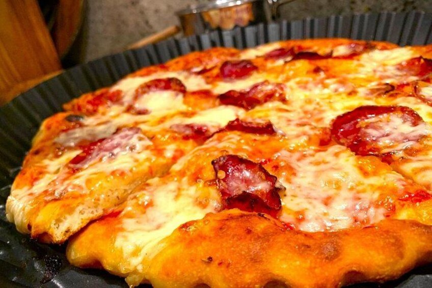 Garnish the pizza with some spicy salami. 1