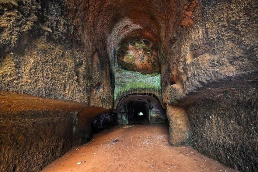A cave with a narrow passageway and a large rock formation. 2