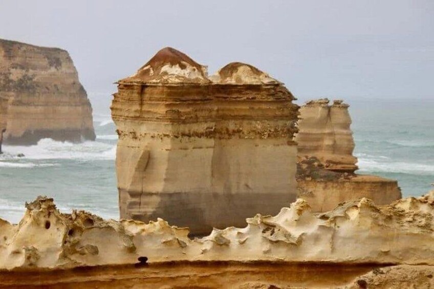 A coastal landscape with prominent rock formations and cliffs. 2