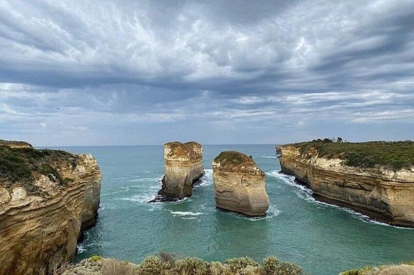 A coastal landscape with prominent rock formations and cliffs. 3
