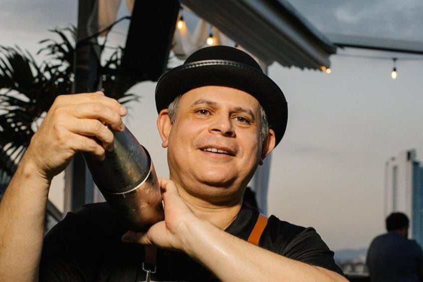 A person holding a cocktail shaker. 2