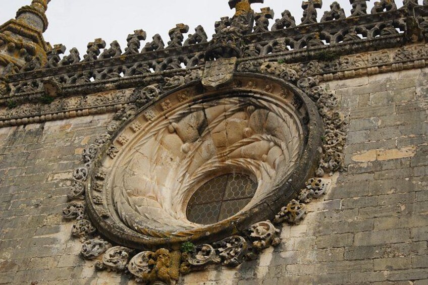 A circular architectural feature with intricate carvings and a decorative border. 3