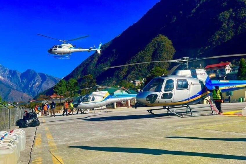 A helicopter on a helipad with mountains in the background. 3