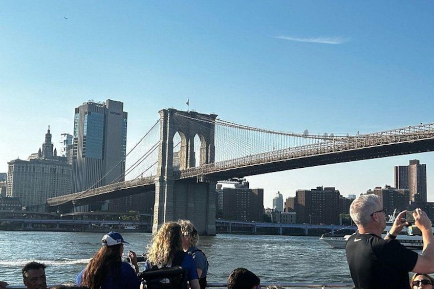 A bridge spanning a river with a city skyline in the background. 5