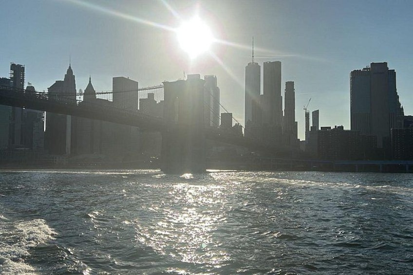 A river with a bridge and a city skyline in the background. 2