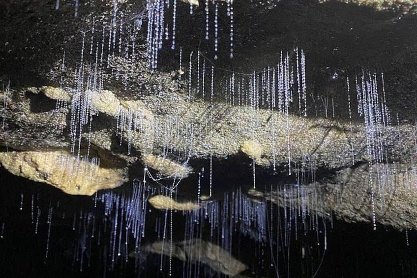 A cave with stalactites hanging from the ceiling and stalagmites rising from the ground. 2