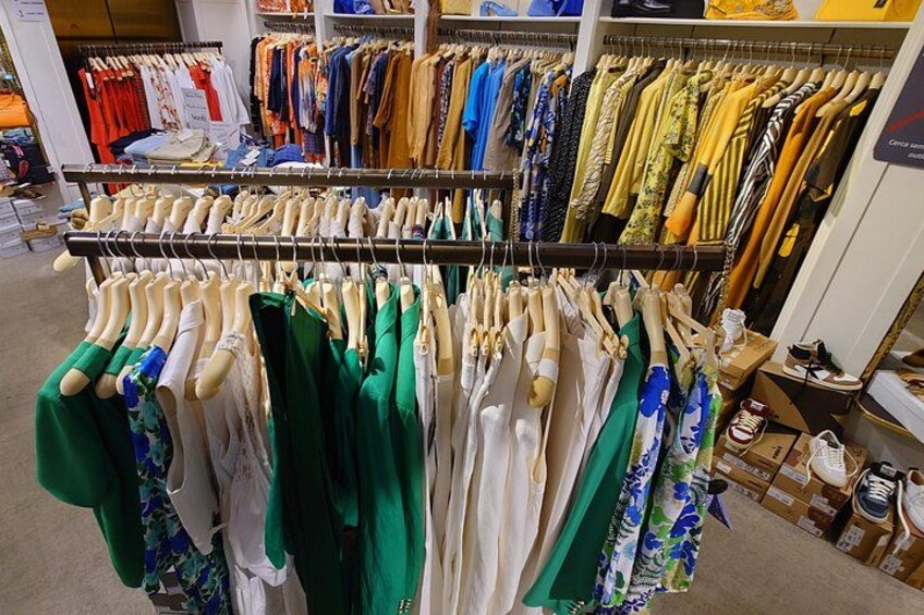 A clothing store with racks of various garments. 3