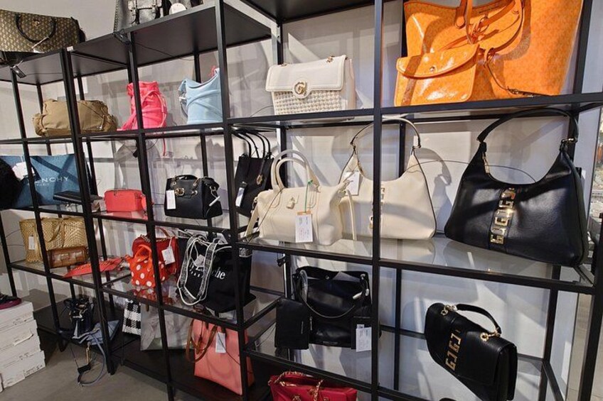 A display of handbags on shelves. 4