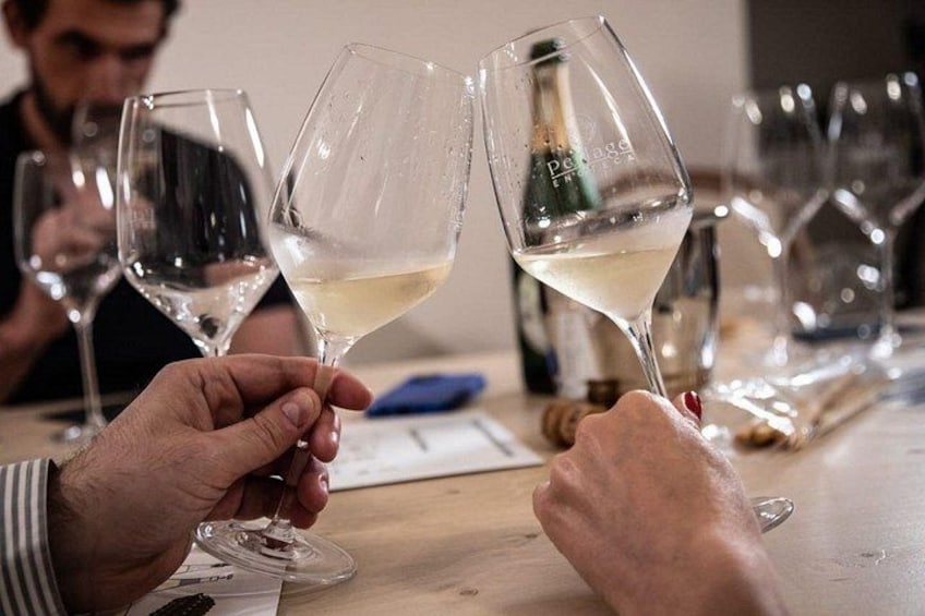People holding wine glasses at a table. 5
