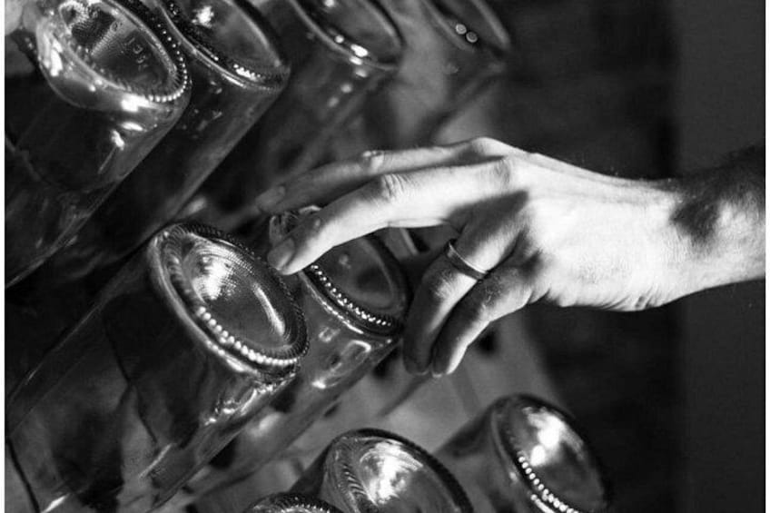 A hand reaching for a bottle. 3