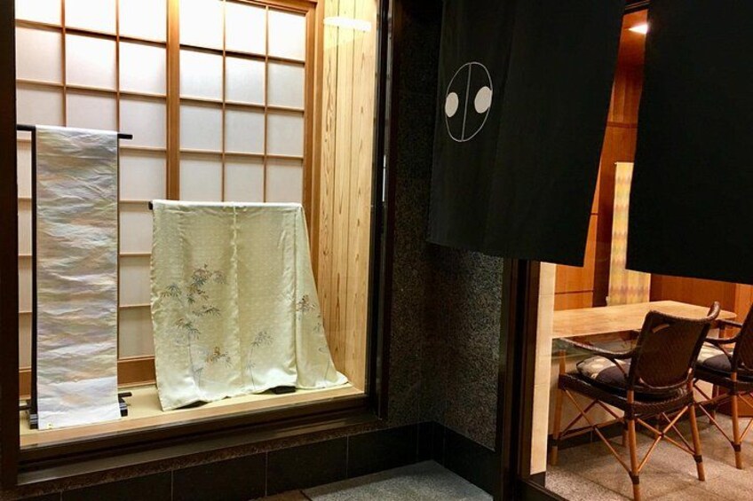 A traditional Japanese room with tatami flooring, a shoji screen, and a table with chairs. 3