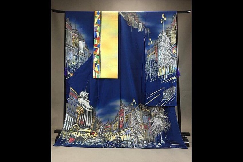 A blue fabric with a cityscape design, including buildings and a river. 1