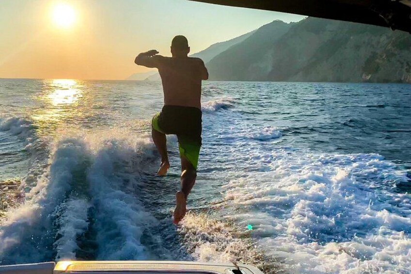 A person surfing on a wave with a sunset in the background. 5