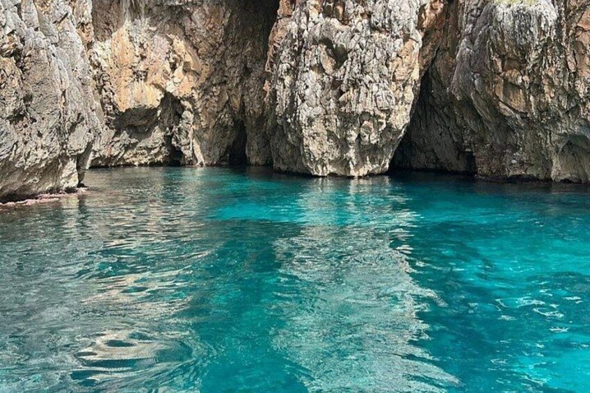 A turquoise sea with rocky cliffs. 1