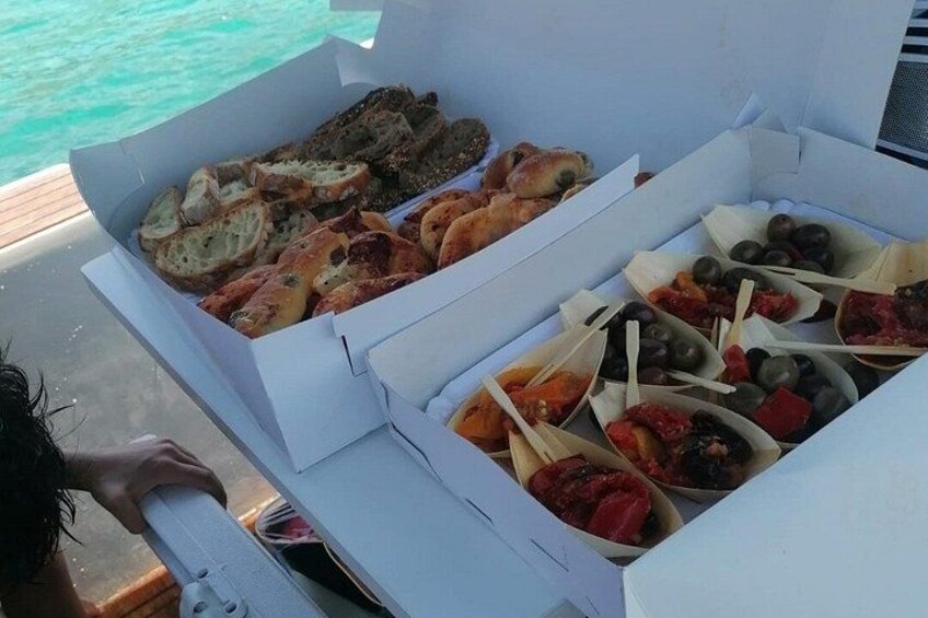 A box of assorted snacks on a boat. 2