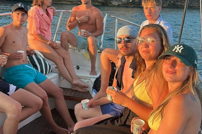 A group of people on a boat with water in the background. 2