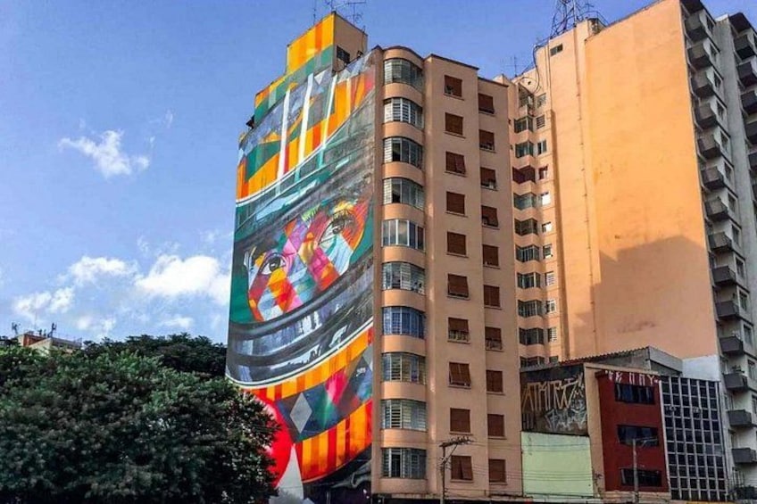 A tall building with a colorful mural on its side. 5
