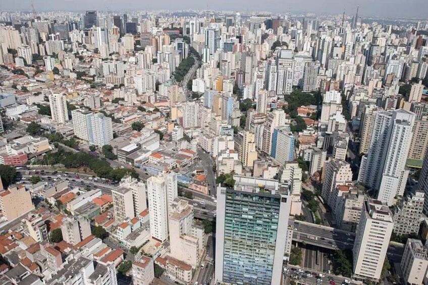 A densely packed urban area with numerous high-rise buildings and a mix of residential and commercial structures. 4