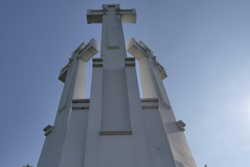 A tall white church steeple with a cross at the top. 4