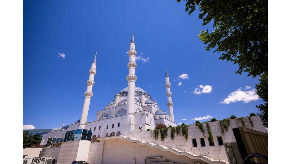 A mosque with three minarets and a large dome. 2