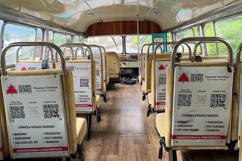 The interior of a bus with QR codes and text on the seats. 4