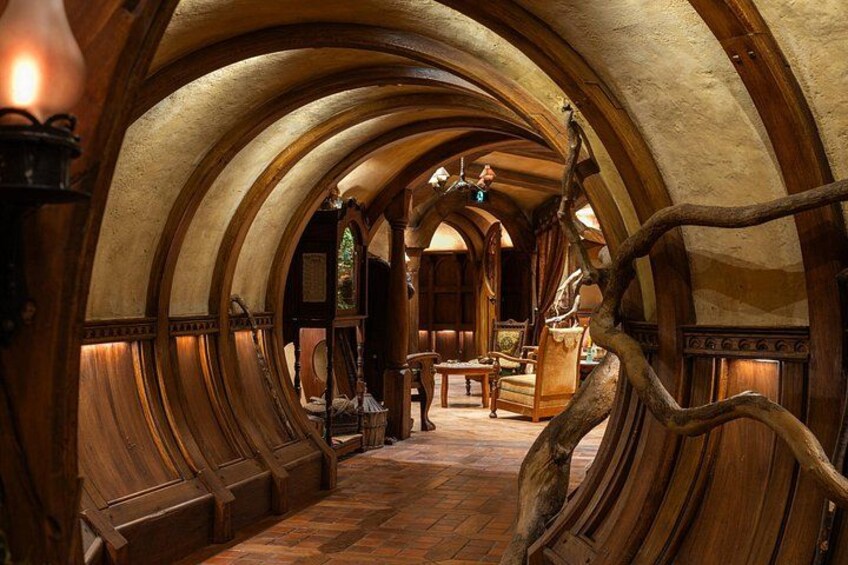 A wooden interior with arched ceilings and a central wooden tree trunk. 4