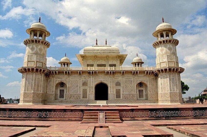 A large, ornate building with domes and minarets, featuring intricate architectural details and a grand entrance. 2