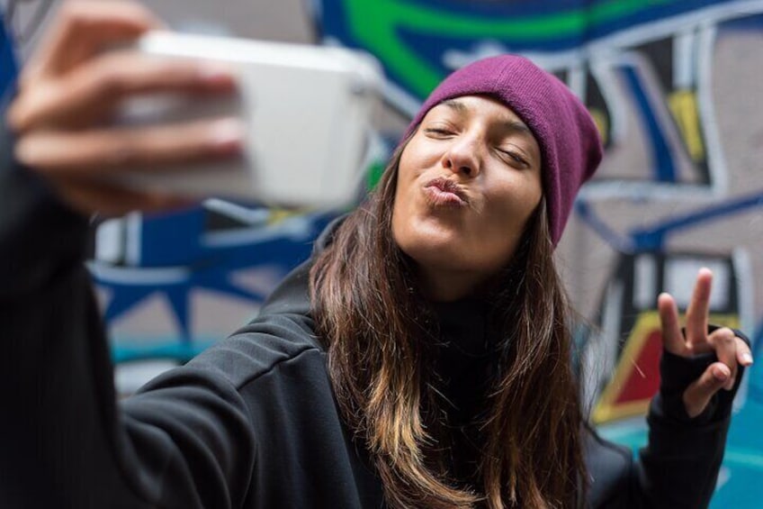 A person taking a selfie with a smartphone. 1