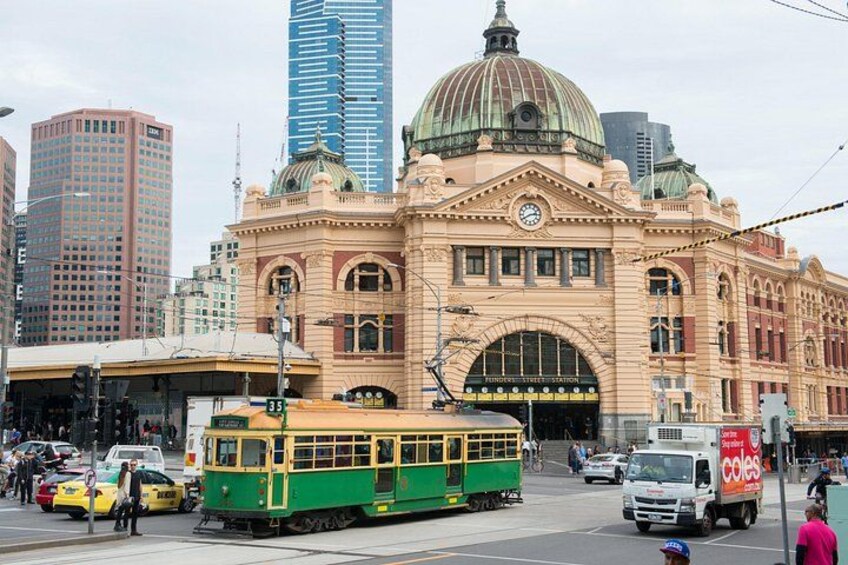 A tram, a train, and a building with a dome. 4
