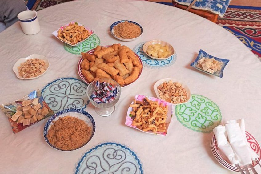 A table with various dishes and bowls of food. 4