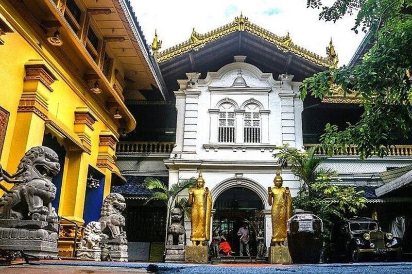 A temple with golden statues and lion statues in front. 4
