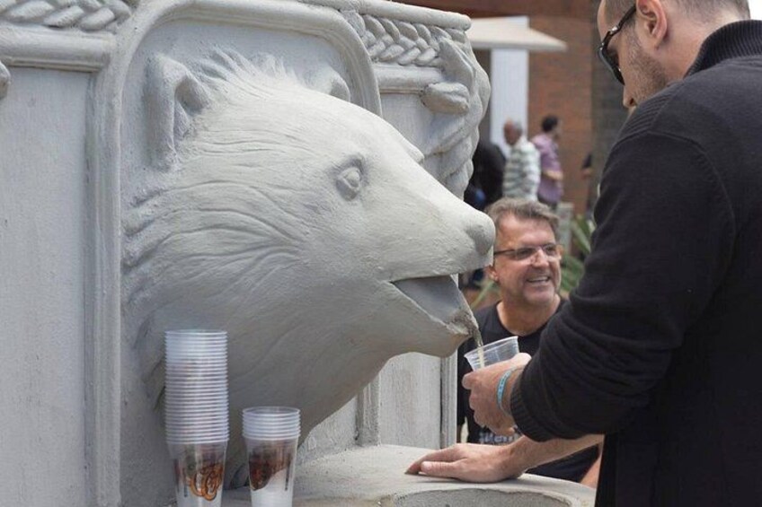 A sculpture of a polar bear's head with stacks of plastic cups beside it. 2